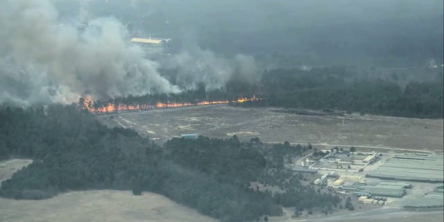 Smoke billows into the sky from New Jersey's latest wildfire