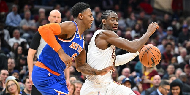 Caris LeVert, right, of the Cleveland Cavaliers goes to the basket around RJ Barrett of the New York Knicks during the third quarter at Rocket Mortgage Fieldhouse March 31, 2023, in Cleveland.