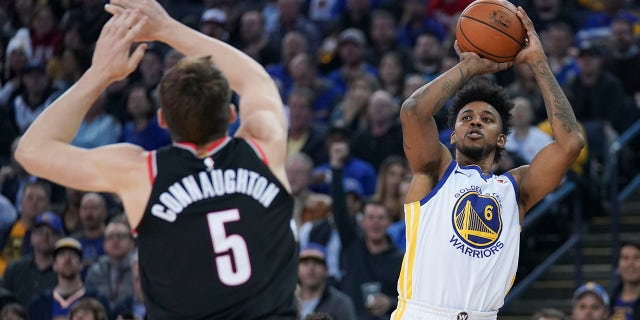 Golden State Warriors guard Nick Young shoots the basketball against Portland Trail Blazers guard Pat Connaughton at Oracle Arena on Dec. 11, 2017, in Oakland, California.