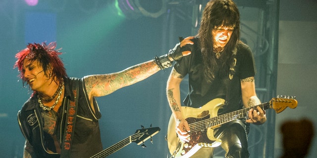  Nikki Sixx and Mick Mars of Motley Crue perform on July 15, 1999.