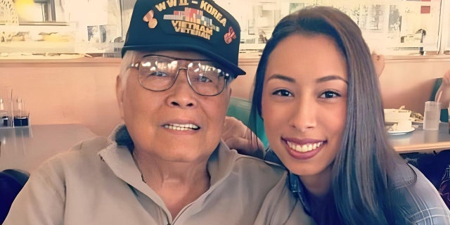 Nina Cashs father Francisco smiling next to his granddaugher