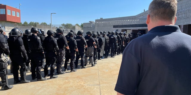 Officers preparing to enter a county jail to end a standoff