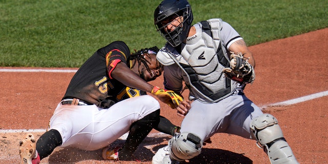 Pittsburgh Pirates' Oneil Cruz (15) is injured as he is tagged out attempting to score by Chicago White Sox catcher Seby Zavala during the sixth inning of a baseball game in Pittsburgh, Sunday, April 9, 2023. A bench clearing brawl ensued as a result of the play.