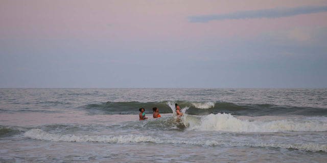 People spending time with their friends at the edge of the water during Orange Crush o