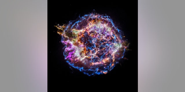 An image from NASA’s Chandra X-ray Observatory shows the location of different elements in the remains of the explosion: silicon (red), sulfur (yellow), calcium (green) and iron (purple). Each of these elements produces X-rays within narrow energy ranges, allowing maps of their location to be created. The blast wave from the explosion is seen as the blue outer ring.