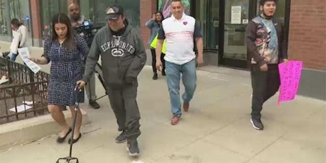 Jose Palencia, a disabled father, and his family walk over to the press as they speak out about how Palencia was denied access to Columbia College campus' restroom by security, April 4, 2023.