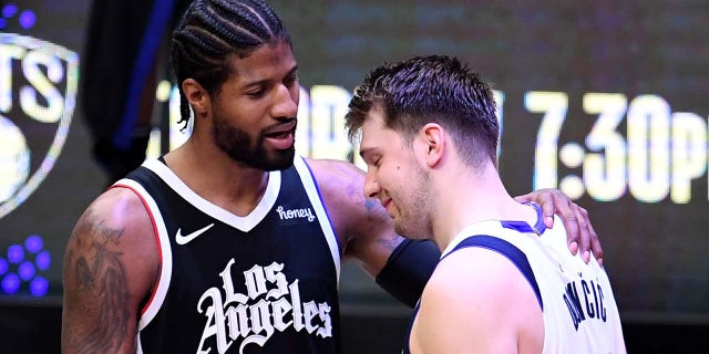 Paul George #13 of the LA Clippers comforts Luka Doncic #77 of the Dallas Mavericks as the Dallas Mavericks beat the Dallas Mavericks 126-111 in a Western Conference first round NBA playoff game seven on Sunday, June 6, 2021 at the Staples Center in Los Angeles. The LA Clippers advanced to the second round 126-111. .