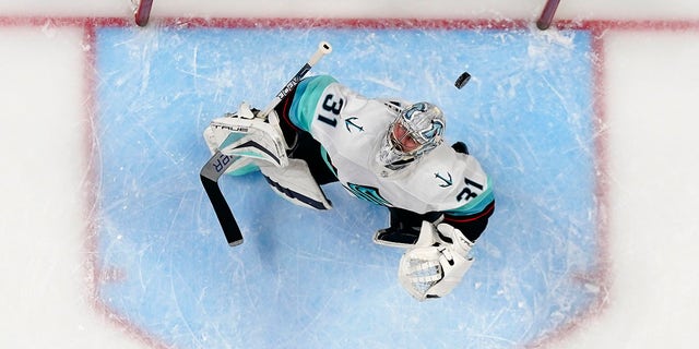Seattle Kraken goaltender Philipp Grubauer (31) eyes the puck as it flies over his head during the first period in Game 1 of the team's first-round NHL hockey playoff series against the Colorado Avalanche on Tuesday, April 18, 2023, in Denver 