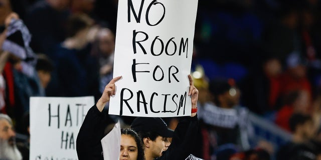 New York Red Bulls supporters hold up signs prior to the Major League Soccer game against the Houston Dynamo on April 15, 2023, at Red Bull Arena in Harrison, New Jersey.