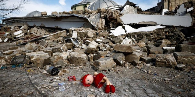 A doll lies on the ground on Feb. 7, 2023, near the site of a collapsed mosque following an earthquake in Hatay, Turkey.