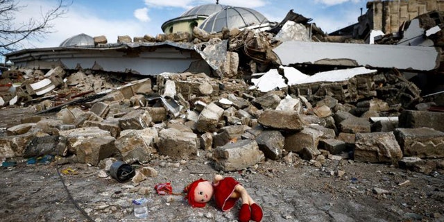 A doll lies on the ground on Feb. 7, 2023, near the site of a collapsed mosque following an earthquake in Hatay, Turkey.