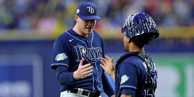 Pete Fairbanks, left, and Francisco Mejia of the Tampa Bay Rays celebrate winning a game against the Boston Red Sox at Tropicana Field April 12, 2023, in St Petersburg, Fla.