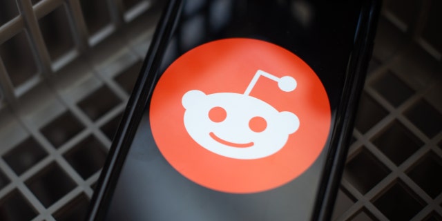 The Reddit logo on a smartphone