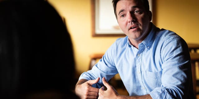 Rep. Jeff Jackson, D-N.C., speaks with Kristin Johnson, owner of The Coffee Bar, in Hickory, North Carolina on July 8, 2021.