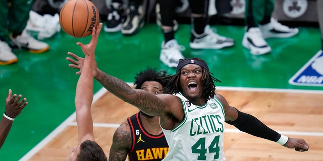 Boston Celtics center Robert Williams III (44) battles for a rebound against Atlanta Hawks guard Bogdan Bogdanovic, left, during Game 2 in the first round of the NBA basketball playoffs, Tuesday, April 18, 2023, in Boston. 