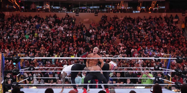 April 2, 2023;  Inglewood, CA, USA;  The Usos (white shirts) interfere in a match between Roman Reigns (black pants) and Cody Rhodes (navy pants) at Wrestlemania Night 2 at SoFi Stadium.