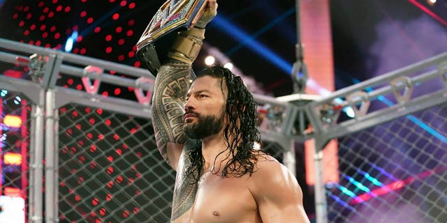 Roman Reigns holds up the WWE Universal Championship after defeating Jey Uso during a match on Oct. 25, 2020, in Orlando, Florida. Reigns and Cody Rhodes will be in the main event of WrestleMania 39 on April 2, 2023, in Los Angeles.