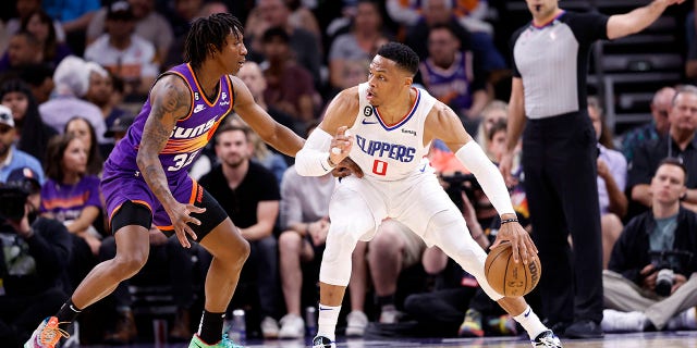 Russell Westbrook #0 of the Los Angeles Clippers posts up on Saben Lee #38 of the Phoenix Suns during the game at Footprint Center on April 09, 2023 in Phoenix, Arizona. The Clippers defeated the Suns 119-114.