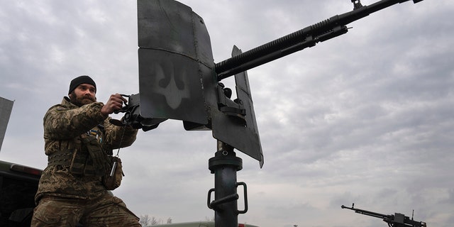 A Ukrainian soldier demonstrates his skills on an air mobile defense weapon at the Antonov airport on the outskirts of Kyiv.