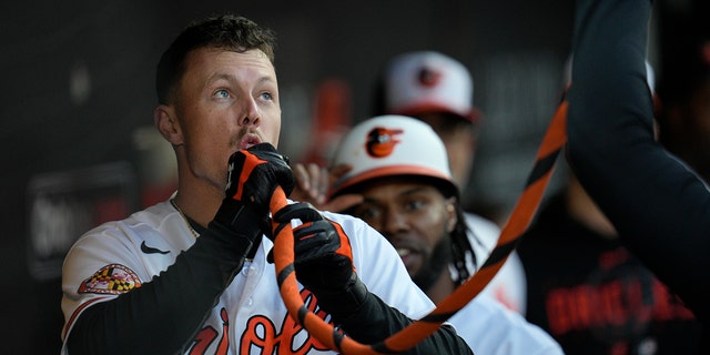 Ryan Mountcastle #6 of the Baltimore Orioles celebrates in the dugout after hitting a home run against the Oakland Athletics in the first inning at Oriole Park at Camden Yards on April 10, 2023 in Baltimore, Maryland.