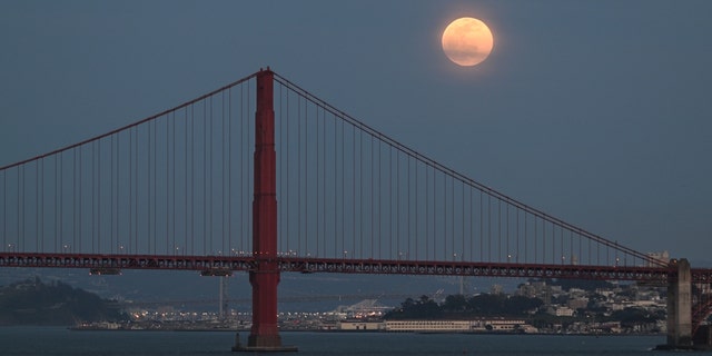 SAN FRANCISCO, CA, UNITED STATES - APRIL 05: The full Pink Moon rises over San Francisco's Golden Gate Bridge as seen from Sausalito in San Francisco, California, United States on April 05, 2023. 