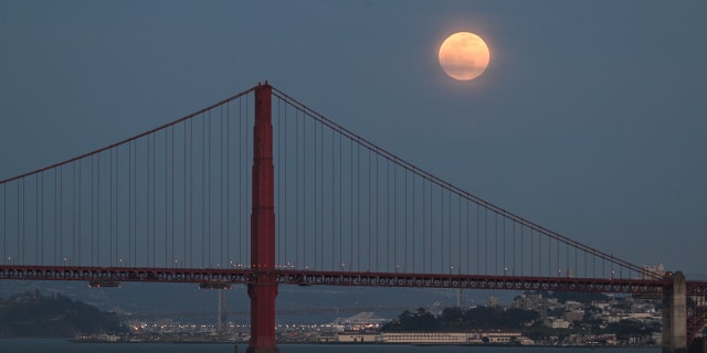 SAN FRANCISCO, CA, UNITED STATES - APRIL 05: The full Pink Moon rises over San Francisco's Golden Gate Bridge as seen from Sausalito in San Francisco, California, United States on April 05, 2023. 