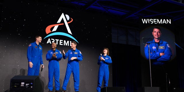 The Artemis II astronauts on a stage