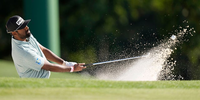 Sahith Theegala hits from the bunker on the 18th hole during the final round of the Masters golf tournament at Augusta National Golf Club on Sunday, April 9, 2023, in Augusta, Ga.