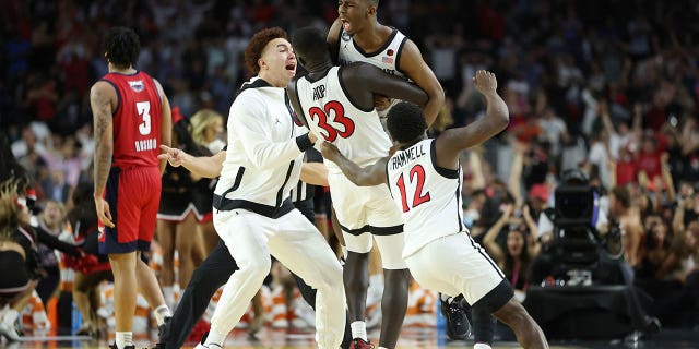 Lamont Butler of the San Diego State Aztecs celebrates with teammates after making a game-winning basket to defeat the Florida Atlantic Owls 72-71 during the Final Four semifinal game at NRG Stadium on April 1, 2023, in Houston, Texas.