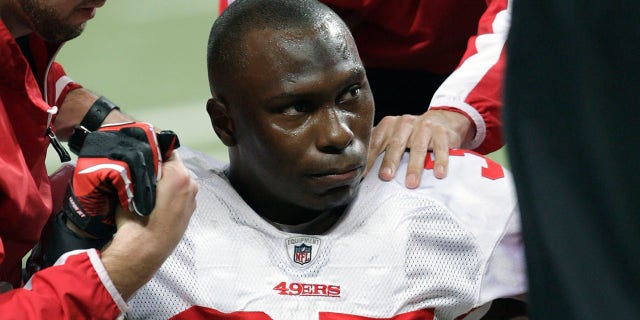 FILE - San Francisco 49ers cornerback Phillip Adams (35) is attended to after injuring his left leg during the third quarter of an NFL football game against the St. Louis Rams on Dec. 26, 2010, in St. Louis.