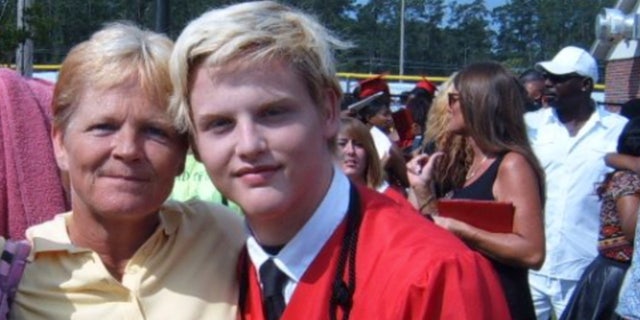 Stephen Smith poses with his mother, Sandy Smith, at his high school graduation. He was killed July 8, 2015, in what South Carolina authorities initially designated a hit-and-run. A second autopsy was performed over the weekend.