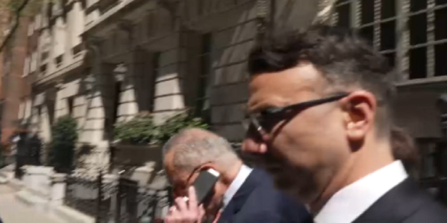 Schumer talks on phone in New York City