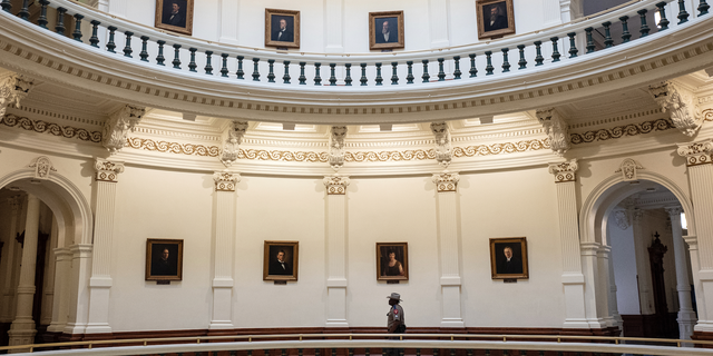 A Texas state trooper walks through the rotunda of the Texas State Capitol in Austin.