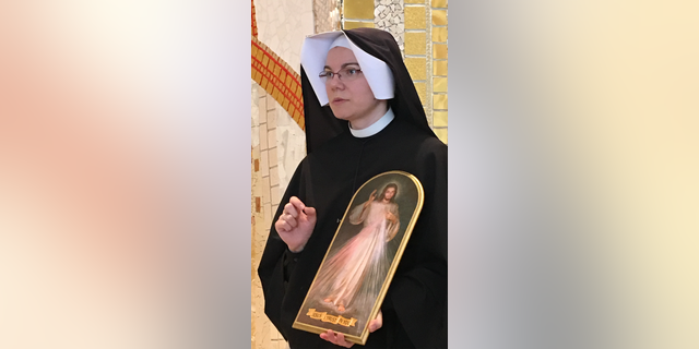 Sr. Donata Farbaniec holds an image of Divine Mercy Jesus.