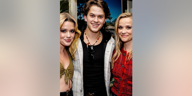 Reese Witherspoon poses with her kids Deacon and Ava Phillippe for her sons new album release party.