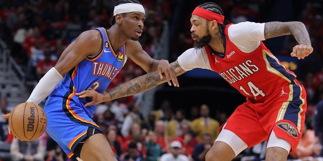 Shai Gilgeous-Alexander #2 of the Oklahoma City Thunder drives against Brandon Ingram #14 of the New Orleans Pelicans during the first half at Smoothie King Center on April 12, 2023 in New Orleans, LA. 