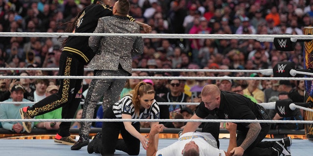 Apr 2, 2023; Inglewood, CA, USA; Snoop Dogg (black attire) and the Miz (suit) and Shane McMahon (white shirt) during Wrestlemania Night 2 at SoFi Stadium.