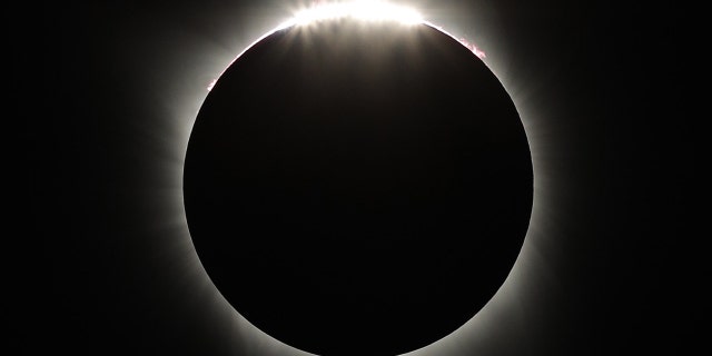 The Diamond Ring appears as the Moon passes beyond the edge of the sun during the Great American Solar Eclipse at Madras High School in Madras, Oregon, on Monday, August 21, 2017.