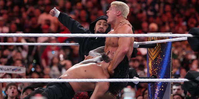 Apr 2, 2023; Inglewood, CA, USA; Solo Siko (jacket) and Cody Rhodes (middle) and Roman Reigns (bottom) during Wrestlemania Night 2 at SoFi Stadium..
