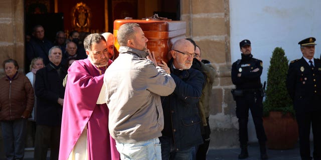 The coffin of the church sacristan who was killed during an attack is carried out of a church after a funeral mass in Algeciras, Spain, on Jan. 27, 2023.