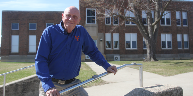 Jerry Sparby in front of school