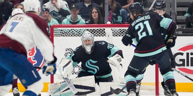 Seattle Kraken goaltender watches the hockey puck