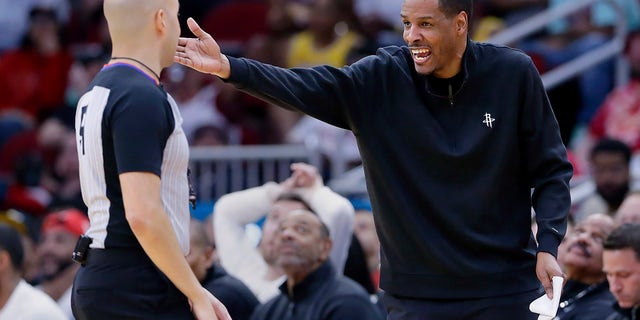 Houston Rockets head coach Stephen Silas, right, argues with referee Aaron Smith about a foul call during the second half of an NBA basketball game against the Los Angeles Lakers, Sunday, April 2, 2023, in Houston.