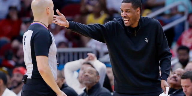 Houston Rockets head coach Stephen Silas, right, argues with referee Aaron Smith about a foul call during the second half of an NBA basketball game against the Los Angeles Lakers, Sunday, April 2, 2023, in Houston.