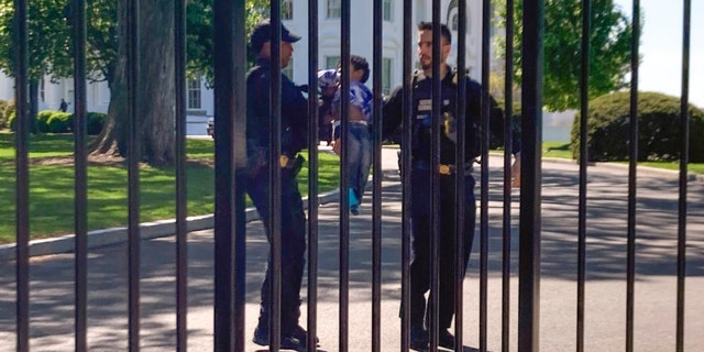U.S. Secret Service uniformed division police officers carry a young child