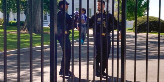 U.S. Secret Service uniformed division police officers carry a young child