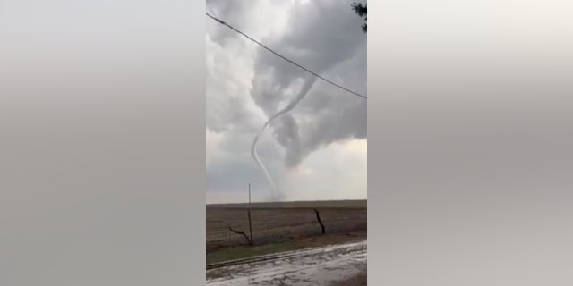 A tornado touches down in Pleasantville, Iowa, on Tuesday, April 4, 2023. The storms moving through the Midwest and South on Wednesday threaten some areas still reeling from a deadly bout of bad weather last weekend. 