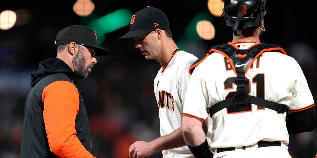 Giants manager Gabe Kapler takes the ball from Taylor Rogers, taking him out of the Los Angeles Dodgers game at Oracle Park on April 10, 2023, in San Francisco.