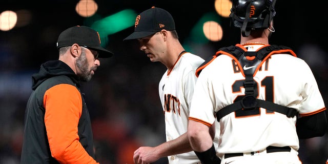 Giants manager Gabe Kapler takes the ball from Taylor Rogers, taking him out of the Los Angeles Dodgers game at Oracle Park on April 10, 2023, in San Francisco.