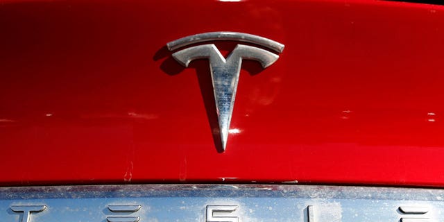 The Tesla company logo sits on an unsold 2020 Model X at a Tesla dealership in Littleton, Colorado, on Feb. 2, 2020.